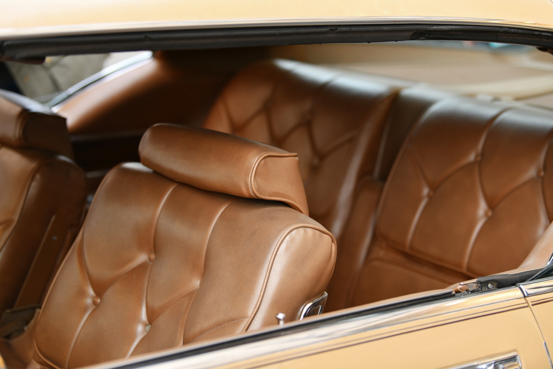 A brown vintage armchair in a car interior A brown vintage armchair in a car interior